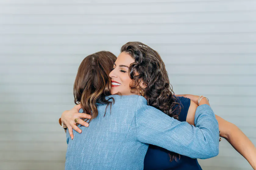 Renée Marino warmly embracing an audience member